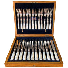 Load image into Gallery viewer, Antique EPNS silver plate fork and knife set featuring Mother-of-Pearl handles with locking royal blue velvet lined golden oak wood box, includes 3 keys. Crafted by Harrison Brothers & Howson, England, circa 1890s. A gorgeous set of cutlery perfect for dessert and fruit service.
In excellent vintage condition, freshly polished. Phillips Montreal appraisal certificate included.
Fork measures 6 1/8 inches
Knife measures 7 1/2 inches
Box measures 11 1/4 x 9 1/4 inches