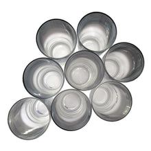 Load image into Gallery viewer, Overhead view of eight silver fade highball glasses showing mirrored silver interior finish