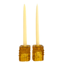 Load image into Gallery viewer, Stunning pair of vintage mid-century brutalist style amber candle holders. Versatile, may be used with tapers or votive candles. Designed by artisan Vladislav Urban for Sklo Union, Rosice Glassworks, Czechoslovakia, circa 1968. A gorgeous way to add glow to your life!
In excellent condition, free from chips/cracks.
Measures 2 3/8 x 2 3/8 x 3 1/8 inches