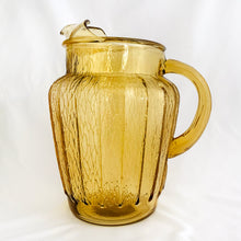 Load image into Gallery viewer, This vintage "Sprucewood Honey Gold" ice lip pressed glass pitcher features a paneled shape with a bark-like design. Crafted by Anchor Hocking, USA, circa 1970s. A great addition to your tablescape or barware! In excellent condition, free from chips. Measures 5 1/2 x 8 inches Capacity 86 ounces
