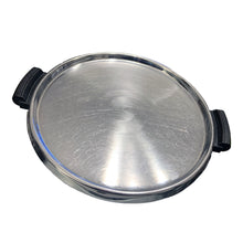 Load image into Gallery viewer, This vintage mid-century modern round stainless steel serving tray with bakelite handles and rolled edge is perfect for entertaining guests. The round shape and steel finish adds a touch of industrial elegance, while the Bakelite handles make it easy to carry. Serve drinks and appetizers in style with this classic tray.
In excellent used vintage condition.
Measures 12 3/4 (without handles)