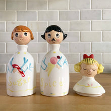 Load image into Gallery viewer, Vintage "Sugar and Spice and Everything Nice" decanters and jar lid. Created by Earl Bernhard and made in Japan. Sweet decorative ceramics! Sugar and Spice decanter jars measure 2 1/8 x 5 1/4 Everything Nice lid measures 2 1/4 x 3 1/8 (chip to underside of rim)