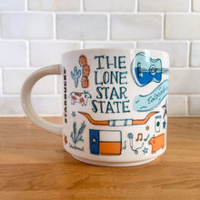 Load image into Gallery viewer, Perfect for your morning cuppa joe! This fabulous collectible TEXAS ceramic mug was produced by Starbucks as part of their "Been There Series" Across The Globe Collection, 2018. A white ceramic mug printed design in shades of blue and orange with orange interior. Celebrate the lonestar state! In excellent condition, free from chips/cracks/wear. Measures 3 5/8 x 3 3/8 inches Capacity 14 ounces