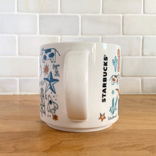 Load image into Gallery viewer, Perfect for your morning cuppa joe! This fabulous collectible TEXAS ceramic mug was produced by Starbucks as part of their "Been There Series" Across The Globe Collection, 2018. A white ceramic mug printed design in shades of blue and orange with orange interior. Celebrate the lonestar state! In excellent condition, free from chips/cracks/wear. Measures 3 5/8 x 3 3/8 inches Capacity 14 ounces