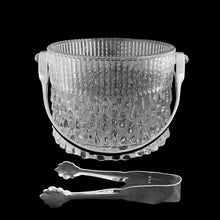 Load image into Gallery viewer, Vintage "TF14" clear pressed glass ice bucket with a texture reminiscent of melting ice with silver toned metal handle and tongs. Crafted exclusively for Teleflora, France, 1970s, tongs marked "USA". This beautiful ice bucket will add sparkle to your bar cart and cocktail service!
In excellent condition, no chips.
Measures 5 x 4 7/8 inches