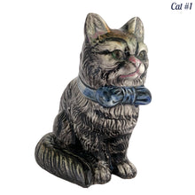 Load image into Gallery viewer, Vintage skillfully hand painted figural tabby cat ceramic planters with intense expressions. These planters have a distinct painting style and date to the 1930s. Features a dark charcoal tabby cat with soulful gray eyes and gray ears, wearing a blue bow tie. In excellent condition, free from chips/cracks/repairs. Impressed mark on the bottom reads, Made in Japan. Measure 6 1/8 x 4 1/2 x 7 inches