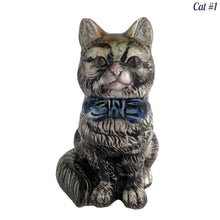 Load image into Gallery viewer, Vintage skillfully hand painted figural tabby cat ceramic planters with intense expressions. These planters have a distinct painting style and date to the 1930s. Features a dark charcoal tabby cat with soulful gray eyes and gray ears, wearing a blue bow tie. In excellent condition, free from chips/cracks/repairs. Impressed mark on the bottom reads, Made in Japan. Measure 6 1/8 x 4 1/2 x 7 inches