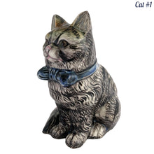Load image into Gallery viewer, Vintage skillfully hand painted figural tabby cat ceramic planters with intense expressions. These planters have a distinct painting style and date to the 1930s. Features a dark charcoal tabby cat with soulful gray eyes and gray ears, wearing a blue bow tie. In excellent condition, free from chips/cracks/repairs. Impressed mark on the bottom reads, Made in Japan. Measure 6 1/8 x 4 1/2 x 7 inches