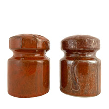 Load image into Gallery viewer, Vintage Takahashi rust lava glaze salt and pepper shakers, angled view showing textured glaze surface, 1970s Japanese stoneware