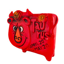Load image into Gallery viewer, Adorable vintage zodiac sign ceramic coin bank of a grinning bull representing the astrological sign of Taurus. The bull is painted red with embossed features including the word "Taurus," tuft of fur and a flower with the dates April 20-May 20. Crafted by Noritake, Japan, circa 1970s and imported by Giftcraft Canada. A great retro collectible for the Taurus in your life!