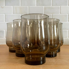 Load image into Gallery viewer, Set of 6 vintage tawny brown Tulip stackable tumblers by Dominion Glass, Canada, 1970s — front-facing glamour shot on butcher block with white subway tile backdrop