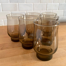 Load image into Gallery viewer, Alternate angled view of 6 vintage Dominion Glass Tulip tumblers in tawny brown, arranged on a butcher block counter, showing the tulip silhouette and stacking capability