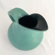 Load image into Gallery viewer, Vintage art deco style teal pitcher vase, hand painted with branches and pink flower blossoms, glazed black on the interior. Produced by Brentleigh Ware, England, circa 1930s. This small pitcher has big style with strong lines! In great vintage condition, free from chips/cracks/repairs, very minor glaze loss on the rim and handle. Marked "Brentleigh Ware, England 75 Samara". Measures 4 1/2 x 5 inches