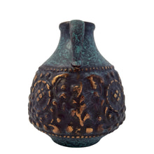 Load image into Gallery viewer, Vintage MCM handled ewer in deep teal, black and the embossed floral pattern in highlighted with gold, on shape 1633-15. Crafted by Jasba, West Germany, 1960s. A wonderful piece of mid-century era art pottery to enhance your home's decor.
In good vintage condition. Minor chip on the floral embossing, no cracks.
Measures 4 1/2 x 6 inches