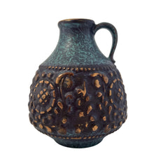 Load image into Gallery viewer, Vintage MCM handled ewer in deep teal, black and the embossed floral pattern in highlighted with gold, on shape 1633-15. Crafted by Jasba, West Germany, 1960s. A wonderful piece of mid-century era art pottery to enhance your home's decor.
In good vintage condition. Minor chip on the floral embossing, no cracks.
Measures 4 1/2 x 6 inches
