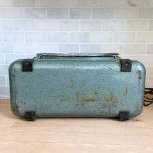 Load image into Gallery viewer, Bottom detail of vintage ZERO box fan showing original black feet, teal enamel housing with surface patina