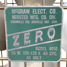 Load image into Gallery viewer, Front view of manufacturer's metal plaque on the front of vintage ZERO Model 4010 box fan with teal enamel body, chrome oval wire grille, four-blade aluminium fan, and McGraw Electric Co. Bersted Mfg. Co., Oakville Ontario Canada