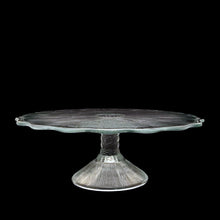 Load image into Gallery viewer, This vintage clear pressed glass round cake stand features a textured pattern radiating from the central rum well and and finished with scalloped edge which is reminiscent of a pressed flower. Maker unknown. A beautiful piece to display cakes and desserts! In excellent condition, free from chips. Unmarked. Measures 12 x 4 1/4 inches