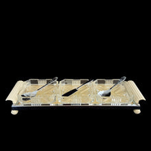 Load image into Gallery viewer, Vintage Art Deco 3-part relish tray featuring ribbed and curled bakelite handles and round feet, removable square cut glass inserts, with chrome-plated spoons and knife. Crafted by Zimco, England, 1950s. The epitome of elegance in entertaining for table or bar.
In excellent vintage condition no chips. There is discolouration on the paper under the glass in the tray, but it can easily be replaced.
Measures 14 x 4 3/4 x 1 3/4 inches, each glass insert measures 3 7/8 x 3 7/8 x 1 inches