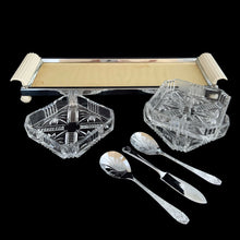 Load image into Gallery viewer, Vintage Art Deco 3-part relish tray featuring ribbed and curled bakelite handles and round feet, removable square cut glass inserts, with chrome-plated spoons and knife. Crafted by Zimco, England, 1950s. The epitome of elegance in entertaining for table or bar.
In excellent vintage condition no chips. There is discolouration on the paper under the glass in the tray, but it can easily be replaced.
Measures 14 x 4 3/4 x 1 3/4 inches, each glass insert measures 3 7/8 x 3 7/8 x 1 inches
