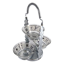 Load image into Gallery viewer, A super cool piece of mid-century history in this Hollywood regency style 3-tier chrome relish or snack caddy featuring a leaf medallion and spring handle, with three glass bowls with a pattern of silver birds and botanicals on a frosted band and silver ric rac detail below the rim. Crafted by the Libbey Glass Company, USA, circa 1960s. Wow your guests with this fabulous and practical serving piece for condiments, bar snacks or sundae toppings!
