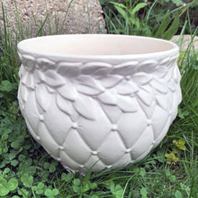 Load image into Gallery viewer, A large vintage "Tierra Cushion" jardiniere or planter pot, glazed in matte white featuring three dimensional flowers and leaves atop a diamond quilted body with ribbon handles. This beauty was produced by McCoy Pottery USA, 1950s. An excellent addition to any art pottery collection!