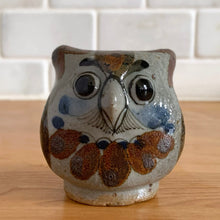 Load image into Gallery viewer, Vintage hand crafted Tonala folk art pottery owl figurine, hand painted and signed by artist Jorge Wilmot, Mexico. This owl has striking eyes, florals in ochre, brown and blue on a gray ground.
In excellent condition, no chips/cracks/repairs.
Measures 2 1/4 x 2 x 2 3/8 inches