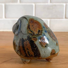 Load image into Gallery viewer, Vintage hand crafted Tonala folk art pottery owl figurine, hand painted and signed by artist Jorge Wilmot, Mexico. This owl has striking eyes, florals in ochre, brown and blue on a gray ground.
In excellent condition, no chips/cracks/repairs.
Measures 2 1/4 x 2 x 2 3/8 inches