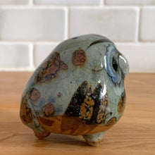 Load image into Gallery viewer, Vintage hand crafted Tonala folk art pottery owl figurine, hand painted and signed by artist Jorge Wilmot, Mexico. This owl has striking eyes, florals in ochre, brown and blue on a gray ground.
In excellent condition, no chips/cracks/repairs.
Measures 2 1/4 x 2 x 2 3/8 inches