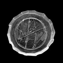 Load image into Gallery viewer, Vintage Tree Branches clear pressed art glass serving plate featuring tree branches on a textured surface reminiscent of the rings in a tree trunk and the free flowing folded rim represent the bark of the tree. Crafted by Kosta Boda, Sweden, 1970s. Perfect for serving small bites, or display on a stand as art.
In excellent condition, no chips.
Measures 8 inches
