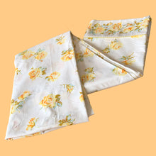 Load image into Gallery viewer, Vintage Rose Romance queen size flat poly/cotton white bed sheet featuring roses in shades of yellow, blue and green, trimmed with yellow lace at the band. Crafted by Texmade, Canada, 1973-1977. A beautiful addition to your bedding collection, or repurpose for crafts, quilting or garment making.
In excellent condition, no stains or tears. Appears unused new old stock. Original label present.
Measures 88 x 106 inches | 224 x 270 centimeters.