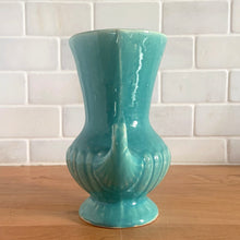 Load image into Gallery viewer, Exceptionally beautiful vintage gloss turquoise art deco vase, featuring a classical grecian urn shape with curled handles. Crafted by McCoy Pottery, early 1940s. This rare vase must for any art pottery collector!
In vintage condition, no cracks/repairs, crazing commensurate with age. Maker's mark on the bottom.
Measures 4 5/8 x 6 inches