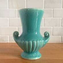 Load image into Gallery viewer, Exceptionally beautiful vintage gloss turquoise art deco vase, featuring a classical grecian urn shape with curled handles. Crafted by McCoy Pottery, early 1940s. This rare vase must for any art pottery collector!
In vintage condition, no cracks/repairs, crazing commensurate with age. Maker's mark on the bottom.
Measures 4 5/8 x 6 inches