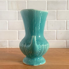 Load image into Gallery viewer, Exceptionally beautiful vintage gloss turquoise art deco vase, featuring a classical grecian urn shape with curled handles. Crafted by McCoy Pottery, early 1940s. This rare vase must for any art pottery collector!
In vintage condition, no cracks/repairs, crazing commensurate with age. Maker's mark on the bottom.
Measures 4 5/8 x 6 inches