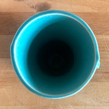 Load image into Gallery viewer, Exceptionally beautiful vintage gloss turquoise art deco vase, featuring a classical grecian urn shape with curled handles. Crafted by McCoy Pottery, early 1940s. This rare vase must for any art pottery collector!
In vintage condition, no cracks/repairs, crazing commensurate with age. Maker's mark on the bottom.
Measures 4 5/8 x 6 inches