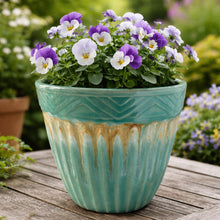Load image into Gallery viewer, Vintage Robinson Ransbottom turquoise drip glaze jardiniere planter – full view showing overall condition, 1960s. Shown placed on a garden deck with pansy flowers.