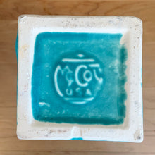 Load image into Gallery viewer, Close-up of the McCoy Pottery maker's mark stamped into the unglazed base