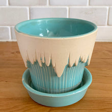 Load image into Gallery viewer, Vintage Art Deco turquoise icicle drip planter with attached underplate #511. Crafted by McCoy Pottery, early 1957. This rare piece is must for any art pottery collector! A lovely way to enhance your home's decor or give as a gift!
In excellent vintage condition, no chips/cracks/repairs. Typical age-related crazing, manufacturer's glaze pops. Maker's marks.
Measures 4 3/8 x 3 3/4 inches
