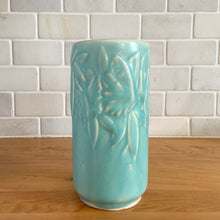 Load image into Gallery viewer, Vintage Art Deco matte turquoise Butterfly Line cylinder vase. Crafted by Nelson McCoy Pottery, 1940s. This rare piece is must for any art pottery collector! A lovely way to enhance your home's decor or give as a gift!
In excellent vintage condition, no chips/cracks/repairs. Typical age-related crazing, manufacturer's glaze pops. Maker's marks.
Measures 3 x 6 inches