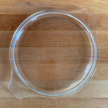 Load image into Gallery viewer, Overhead view of clear PYREX 475-C glass lid interior, showing underside rim and tab handles