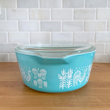 Load image into Gallery viewer, Side profile of vintage turquoise PYREX Butterprint 475-B casserole dish with lid on, displaying full Butterprint pattern and tab handles