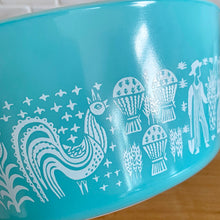 Load image into Gallery viewer, Close-up of turquoise-on-white PYREX Butterprint rooster and wheat pattern on Opalware glass casserole dish exterior