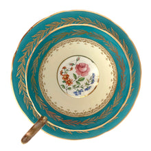 Load image into Gallery viewer, This highly sought after vintage Bone China teacup and saucer with scalloped rim features a hand painted turquoise and pale yellow banded interior on a white ground, lavishly decorated with gold gilt filigree, complemented by colourful floral bouquets in the bottom of the cup and centre of the saucer. Crafted by Aynsley, England. Backstamp indicates production between 1934 - 1950s. A stunning addition to your teacup collection!