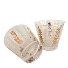 Load image into Gallery viewer, Vintage 2-part glass condiment server featuring alternating 22kt gold leaves and clear leaves on a white stripe and pinecone embossed aluminum lids in chrome caddy. Crafted by Dominion Glass, Canada, 1950s. Love the conical shape of the glass and the styling on the caddy....very mid-century modern and a great way to serve your favourite fixings.
In excellent condition, no chips.
Overall measures 7 3/4 x 4 x 5 1/2 inches