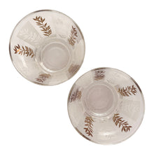 Load image into Gallery viewer, Vintage 2-part glass condiment server featuring alternating 22kt gold leaves and clear leaves on a white stripe and pinecone embossed aluminum lids in chrome caddy. Crafted by Dominion Glass, Canada, 1950s. Love the conical shape of the glass and the styling on the caddy....very mid-century modern and a great way to serve your favourite fixings.
In excellent condition, no chips.
Overall measures 7 3/4 x 4 x 5 1/2 inches