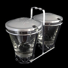Load image into Gallery viewer, Vintage 2-part glass condiment server with rose embossed aluminum lids in a chrome caddy. Crafted by Dominion Glass, Canada, 1950s. Love the conical shape of the glass and the styling on the caddy....very mid-century modern and a great way to serve your favourite fixings.
In excellent condition, no chips.
Overall measures 7 x 3 1/2 x 5 3/8 inches
