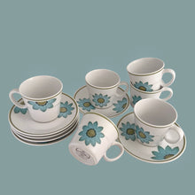 Load image into Gallery viewer, Vintage Progression Up-Sa Daisy high quality stoneware teacup and saucer features an aque blue daisy with moss green and black centres and moss green band at the rim. Crafted by Noritake, Japan, 1966 - 1979. This darling flower pot shaped teacup and saucer will add tons of vintage charm to your table! In excellent condition and appear unused. Free from chips/cracks/repairs. Colours are vibrant. Teacup measures 3 3/8 x 3 inches Saucer measures 6 inches Capacity 8 ounces