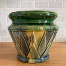 Load image into Gallery viewer, Rare antique Art Deco blended gloss glazed "V" jardiniere planter pot, features an overlapping pointed leaf or sunburst pattern on green, blue and yellow blend of glazes. Crafted by McCoy Pottery, USA, 1920s. This rare vintage planter is highly sought after and a must-have for any McCoy collector or container garden lover!
In excellent vintage condition, no chips/cracks/repairs, age-related crazing, manufacturer's glaze pops, minor hard water marks. Unmarked.
Measures 7 1/4 x 6 1/2 inches
