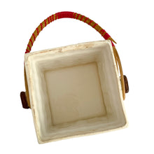 Load image into Gallery viewer, Adorable vintage mid-century colourfully hand painted figural village gingerbread house ceramic cookie jar with wrapped rattan handle. Crafted by Grantcrest, Japan, 1950s. A wonderful addition to your cookie jar collection and kitchen decor! In great vintage condition, no chips, staining at the rim, crazing. Measures 4 5/8 x 4 5/8 x 6 inches (9 inches tall with handle extended)