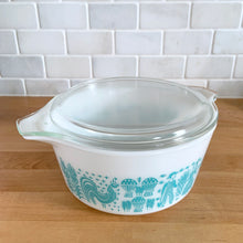 Load image into Gallery viewer, Vintage PYREX Butterprint Model 474-B casserole dish with lid, three-quarter elevated view showing white opalware and turquoise exterior